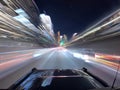 speeding cars in the city on a busy street at night