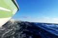 Speeding fishing motor boat with drops of water. Blue ocean sea water wave reflections with fast fishing yacht. Motor boat in the