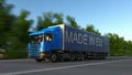 Speeding freight semi truck with MADE IN EU caption on the trailer. Road cargo transportation. 3D rendering