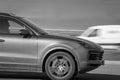 Speeding, high speed car on the road. Front side view of the car. Porsche Cayenne. Motion blur. Riga, Latvia - 31 Mar 2022