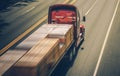 Speeding Semi Truck with Wood Material Load Royalty Free Stock Photo