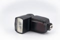 Speedlight isolated on the white background. Camera flash unit features an improved user interface and better durability Royalty Free Stock Photo