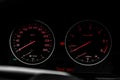 Speedometer arrows with red lights in car. Royalty Free Stock Photo
