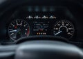Speedometer of a new modern car with an integrated fuel gauge in the tank with blue arrows. Starting engine, with Royalty Free Stock Photo
