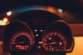 Speedometer scoring high speed in a fast motion. Sporty Car Dashboard Instruments illuminated at night. Rev counter Royalty Free Stock Photo