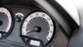 Speedometer in a simple generic motionless stopped car interior object detail closeup, showing speed in kilometers per hour, kmh