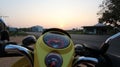 Speedometer on a yellow scooter at sunset in Krabi, Thailand