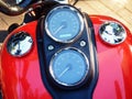 Speedometers on the red tank of the motorcycle top view