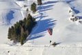 Speedrider with red and gray wing skis in close proximity to a steep slope