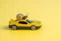 Speedy snail like car racer. Concept of speed and success. Concept of fast taxi or delivery. On yellow background