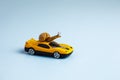 Speedy snail like car racer. Concept of speed and success. Concept of fast taxi or delivery. Yellow car blue background Royalty Free Stock Photo