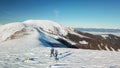 Speikkogel - A drone shot of a couple wearing snow shoes hiking up to Amerinkogel's peak in Austrian Alps. Fresh powder snow Royalty Free Stock Photo