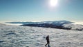 Speikkogel - A drone shot of a woman wearing snow shoes hiking up to the peak of Speikkogel in Austrian Alps