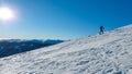 Speikkogel - A man wearing snow shoes hiking up along a steep slope to the peak of Speikkogel in Austrian Alps.