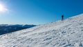 Speikkogel - A man wearing snow shoes hiking up along a steep slope to the peak of Speikkogel in Austrian Alps.