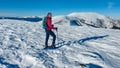 Speikkogel - A woman wearing snow shoes hiking to the peak of Speikkogel in Austrian Alps. The whole slope is covered with snow