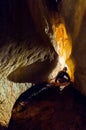 Speleologist exploring a deep cave Royalty Free Stock Photo