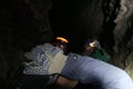 Speleologists in the cave illuminate their way with headlamps Royalty Free Stock Photo