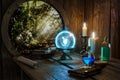 Spell book, Crystal mystic light ball, magic ring, magic potions bottles, burning candle and other various witchcraft accessories
