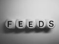 Word feeds spelled on dice Royalty Free Stock Photo