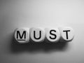 Word must spelled on dice Royalty Free Stock Photo