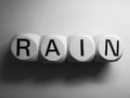 Word rain spelled on dice Royalty Free Stock Photo