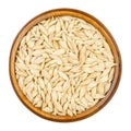 Spelt grains, seeds with outer husk in wooden bowl