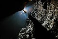 Spelunker abseiling in a cave