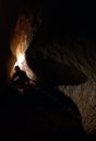 Spelunker exploring a cave Royalty Free Stock Photo