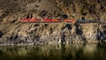 Long Cargo Train travelling along the Steep Cliffs of the Thompson River Canyon