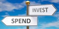 Spend and invest as different choices in life - pictured as words Spend, invest on road signs pointing at opposite ways to show