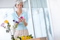 Spend a little time every day doing what you love. a senior woman enjoying some flower arranging at home. Royalty Free Stock Photo