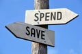 Spend and save - wooden signpost Royalty Free Stock Photo