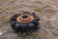 The spend and unusable tire of some heavy machinery lies on the ground.