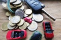 Spending all savings on a car concept with toy vehicle, money and car key on wooden background Royalty Free Stock Photo