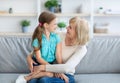 Happy mature woman embracing her granddaughter and talking Royalty Free Stock Photo