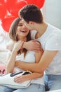 Spending nice time at home. Beautiful young loving couple bonding to each other and smiling. Celebrating Saint Valentines day. Royalty Free Stock Photo