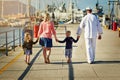 Spending quality time with daddy before he leaves. Rearview shot of a family with young children walking along a harbor Royalty Free Stock Photo