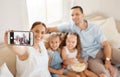 Spending quality time with the family. a woman taking a selfie at home with her family. Royalty Free Stock Photo