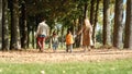 Spending time in nature with kids. Back view of a family holding hands and walking together in the park Royalty Free Stock Photo