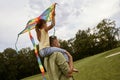 Spending time with super dad. Rear view of a little girl sitting on shoulders of her father and playing with colorful Royalty Free Stock Photo