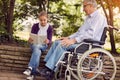 Spending time together reading book outdoor granddaughter and di Royalty Free Stock Photo