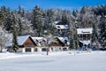 Spending winter holidays concept in idyllic wooden house in snowfall beside lake, Kranjska Gora, Slovenia