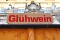 Sign saying `GlÃÂ¼hwein`, meaning `Mulled wine` in German, at sales booth selling hot spiced wine during Christmas market