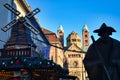 Silhouette of pilgrim statue called `Jakobspilger`, with Christmas market sales booth and Speyer Cathedral in background