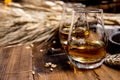 Speyside scotch whisky tasting on old dark wooden vintage table with barley grains Royalty Free Stock Photo