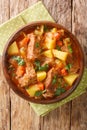 Spezzatino di manzo with potatoes, carrots and celery close-up in a bowl. vertical top view Royalty Free Stock Photo