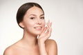 SPF factor cosmetic cream on face. UV care beautiful girl face