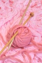 Sphere of pink wool with needles