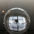 Sphere reflects a grid-patterned window in the background, captu Royalty Free Stock Photo